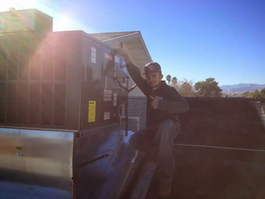 HVAC technician performing Air Duct Repair on a rooftop unit in South San Gabriel